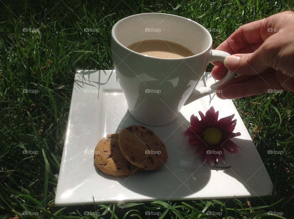 Enjoying a cup of coffee outdoors on a beautiful spring day.