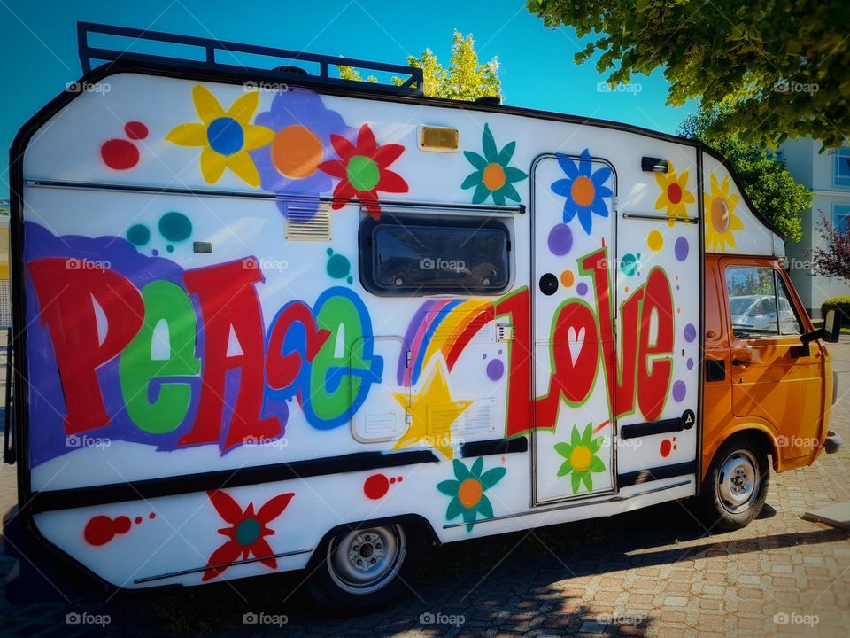 whimsical and colorful camper with a hymn to peace and love designed