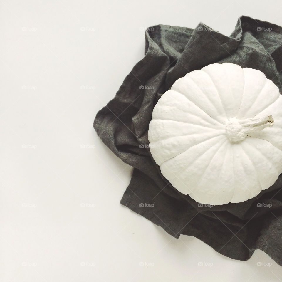 Pumpkin on cloth against white background