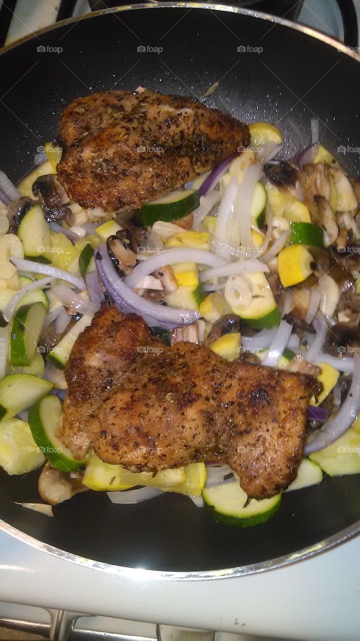 Skinless chicken with zucchini ,onions and garlic. At home cooking up a healthy recipe
