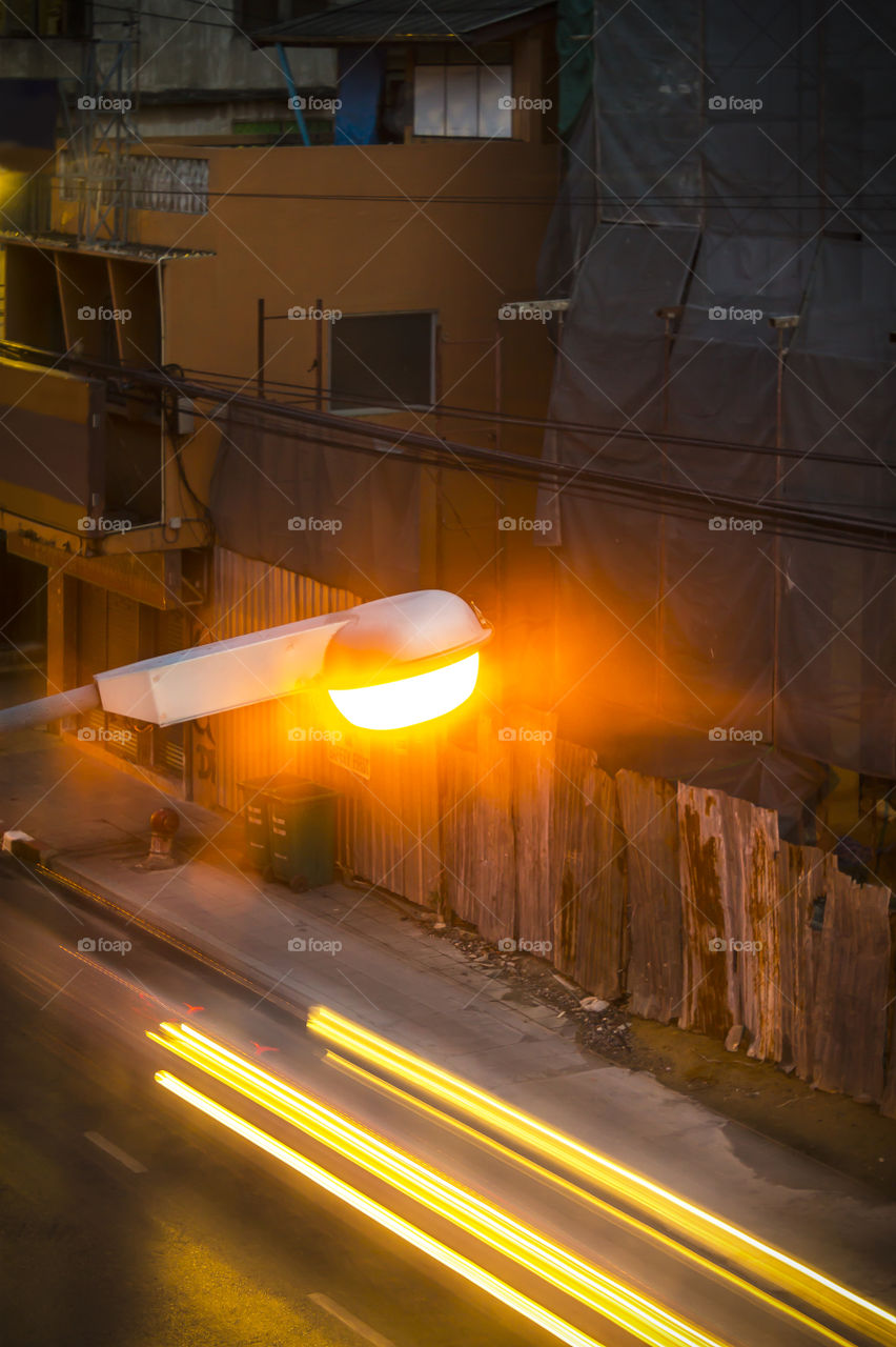 Street lamp and lighting car on the road