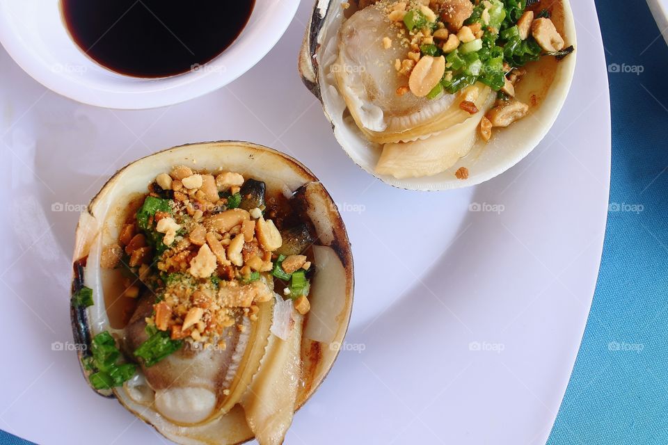 Grilled Scallop. Seafood with spicy sauce.