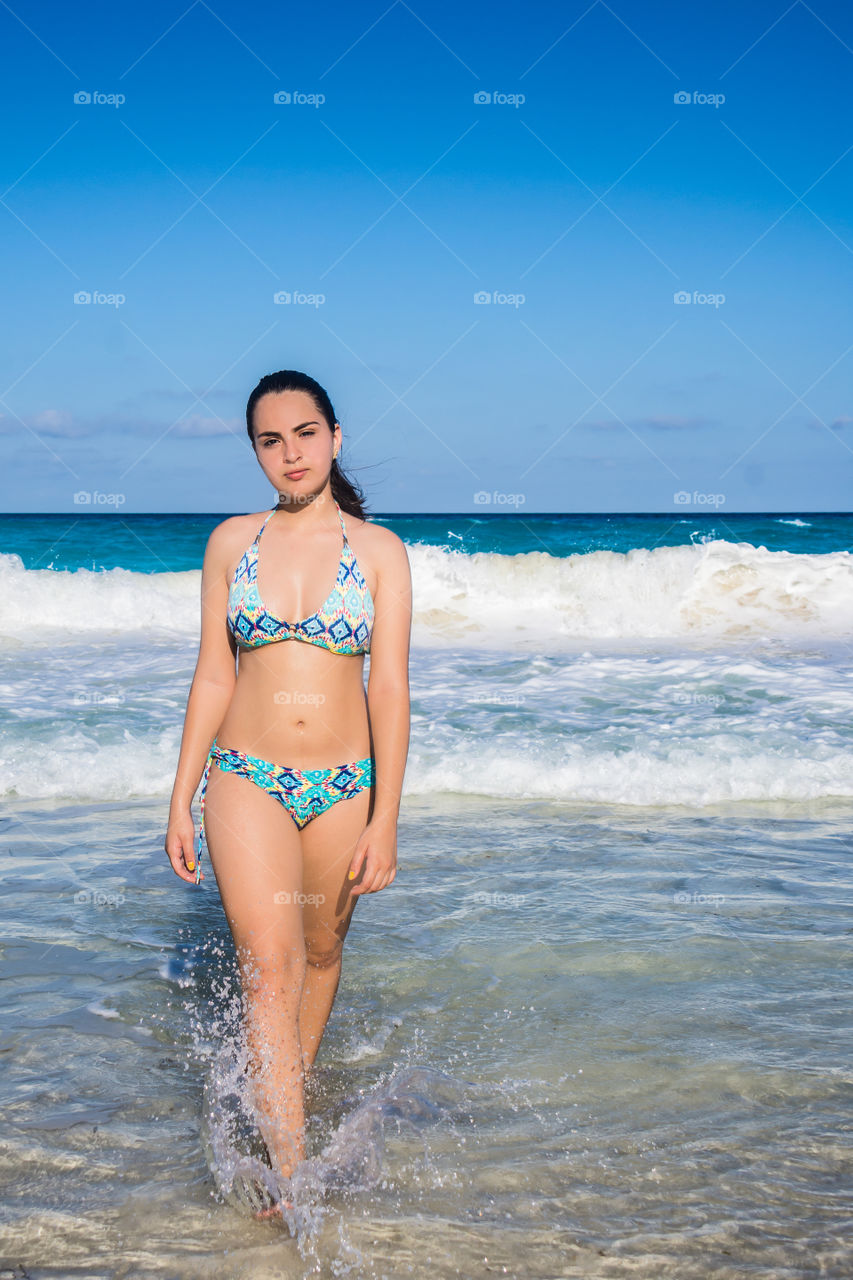 Beautiful girl walking on the beach 