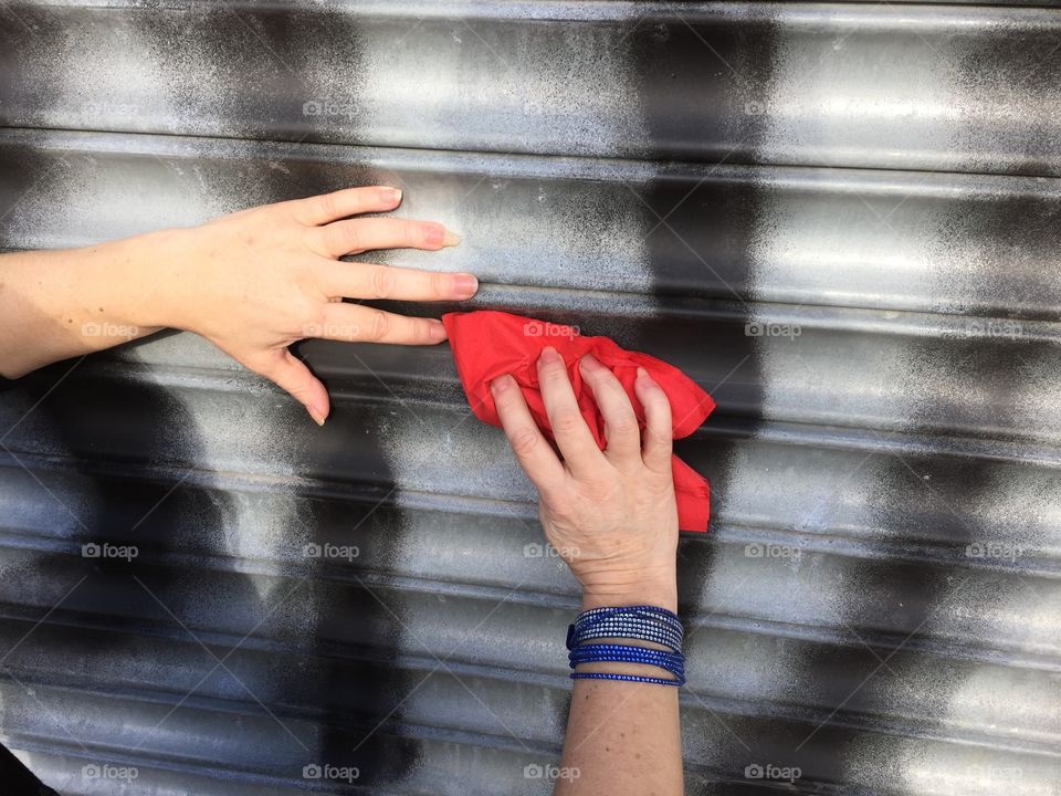 Close-up of person cleaning graffiti