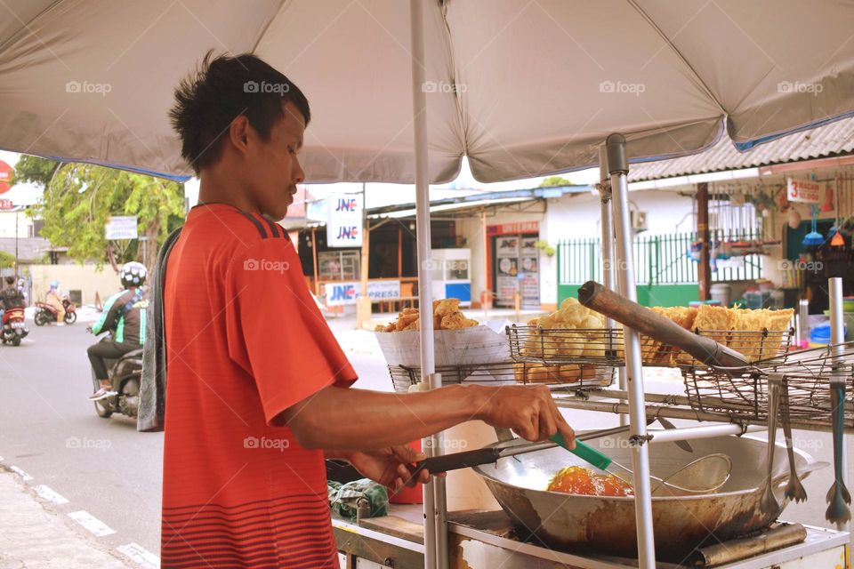 fried food vendors selling on the side of the road in West Jakarta