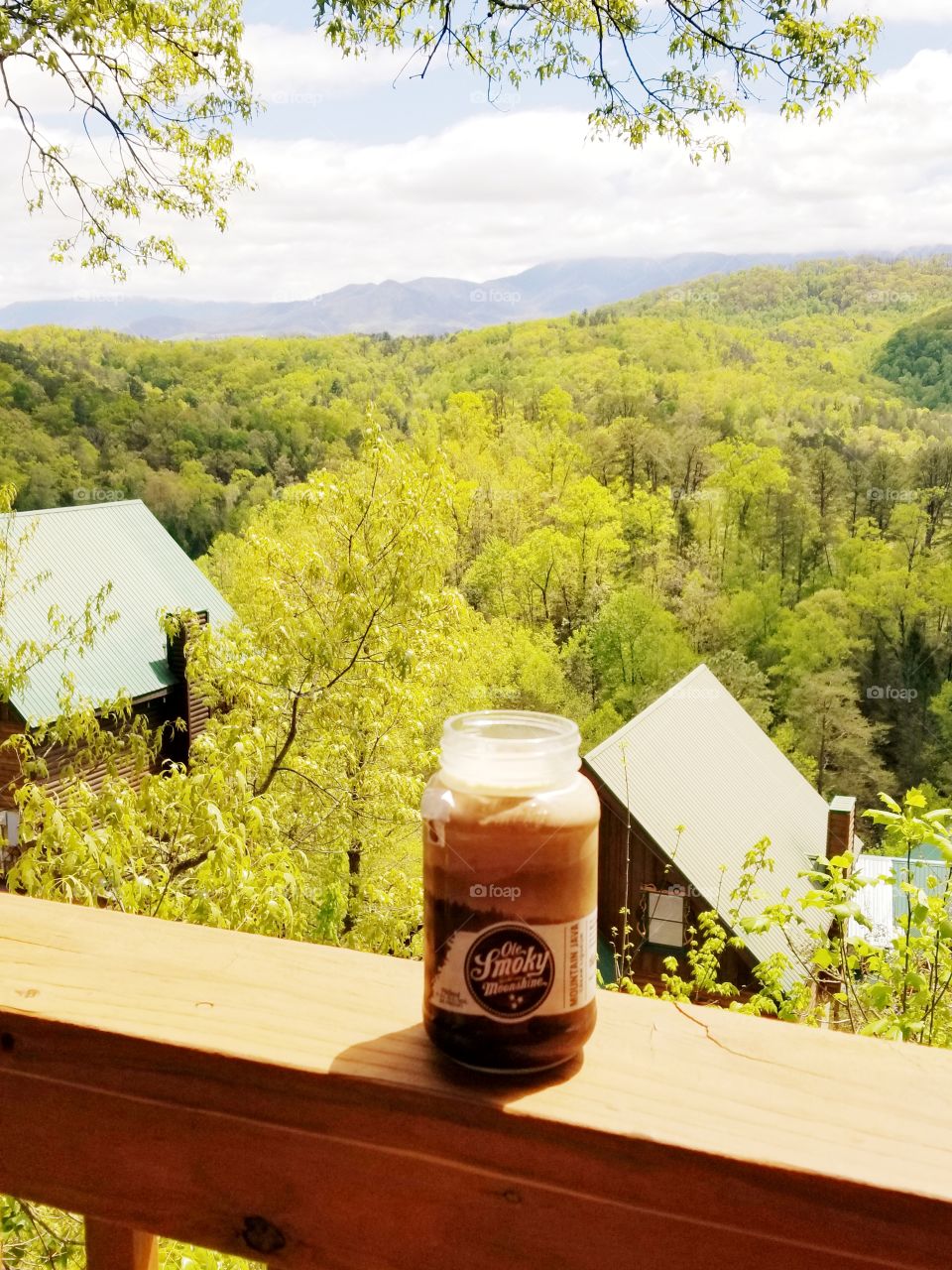 Smoky mountain liquid breakfast in a jar, creamy java Ole Smoky moonshine for a great morning with a spectacular view of fluffy white cloud filled sky.