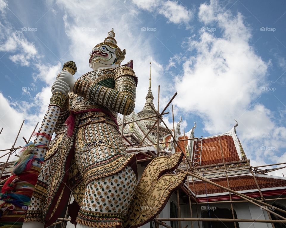 The most famous sculpture of giant at Temple of  Dawn (Wat Arun) in Bangkok Thailand 