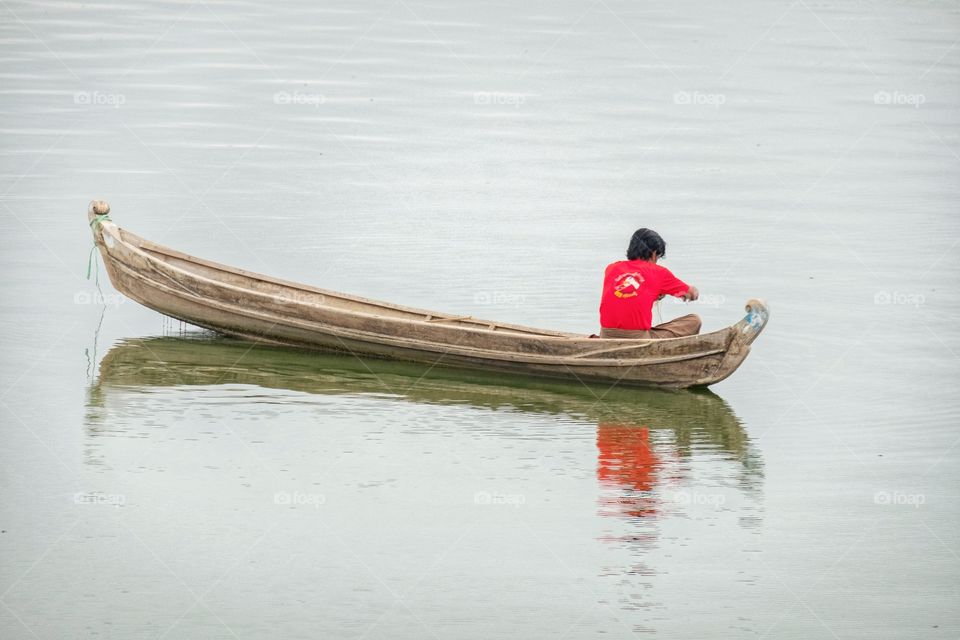 Local life style of fisherman in Early morning at Uben bridge , the longest wooden bridge in the world.