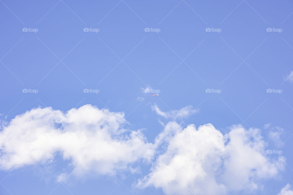 The beauty of clouds and the plane in the sky.