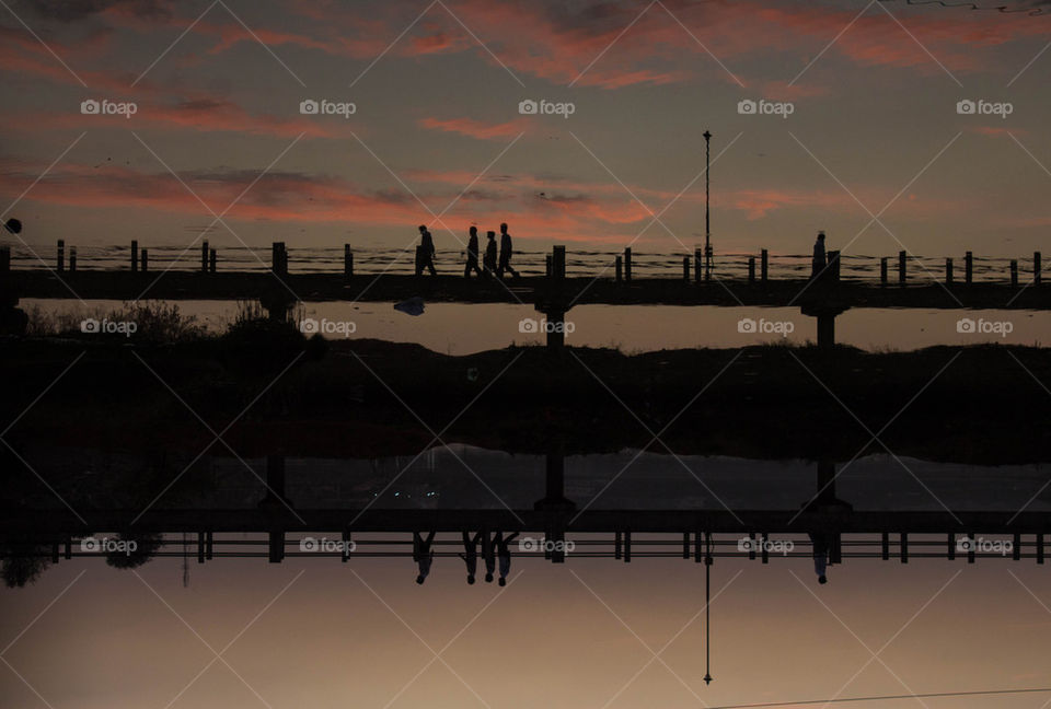 Silhouette of bridge over lake