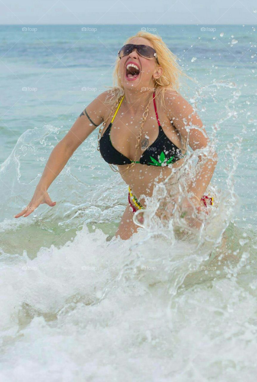 Girl in Bikini playing in the water at a tropical beach in Florida