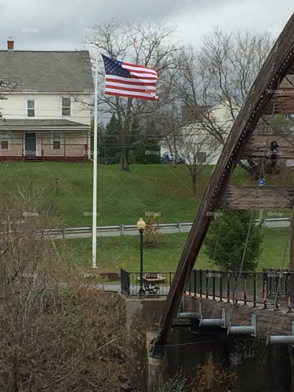 Gateway crossing walking bridge and American flag