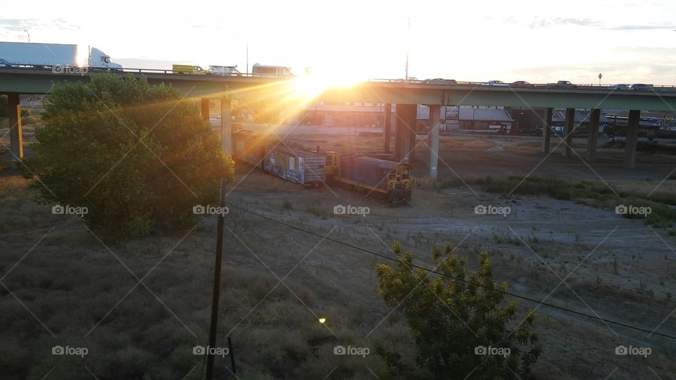 sunrise over I-5 interstate train yard