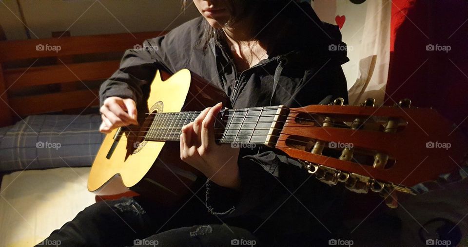 A moment in our personal space, playing the guitar, a very beautiful musical instrument and a spectacular sound