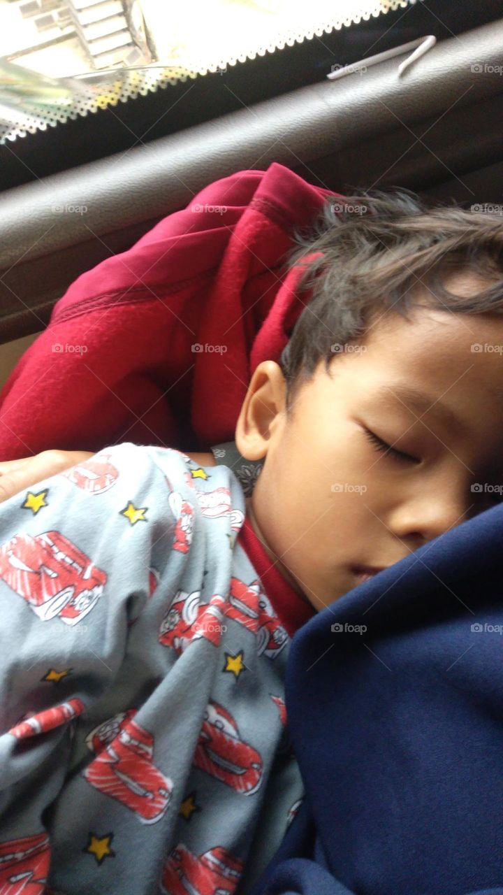 boy sleep tight during the journey