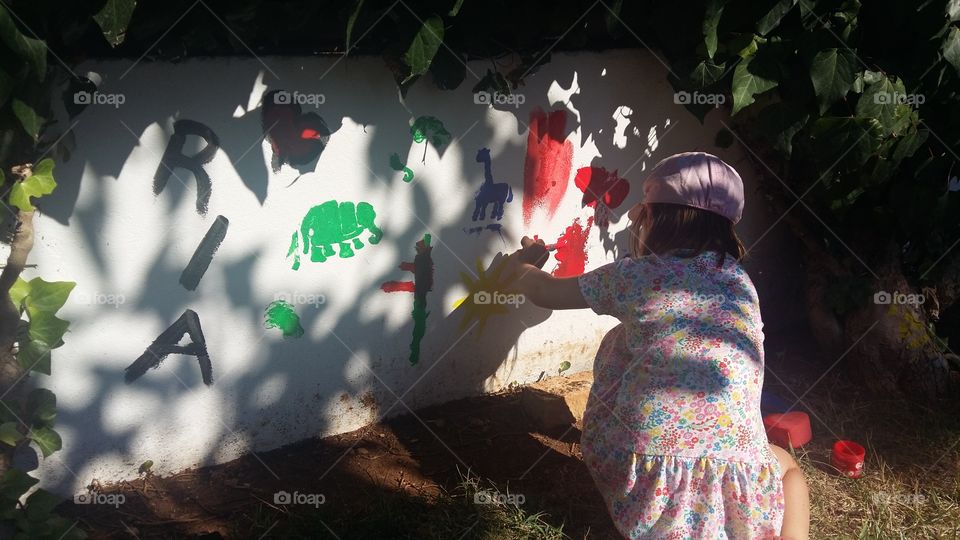 child coloring the wall