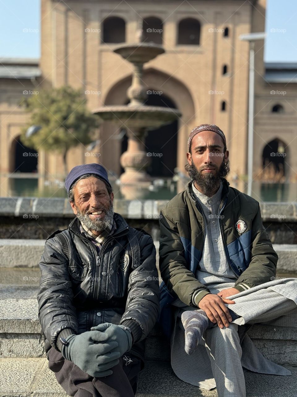Feb-2024. Kashmir, India. Two Kashmiri men relaxing in a park area.