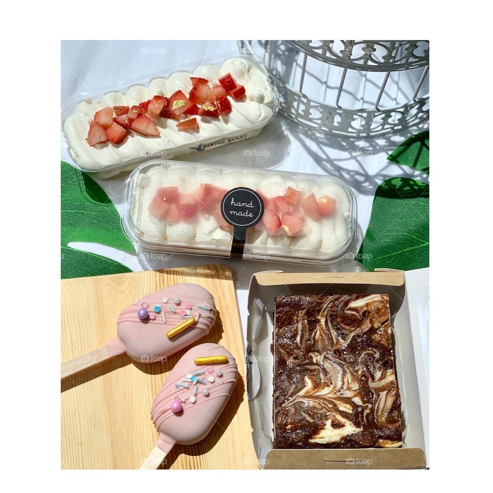 Assorted desserts in cake popsicles, strawberry shortcakes and cheesecake brownies 