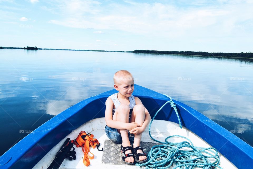 Boy sitting in a boat 