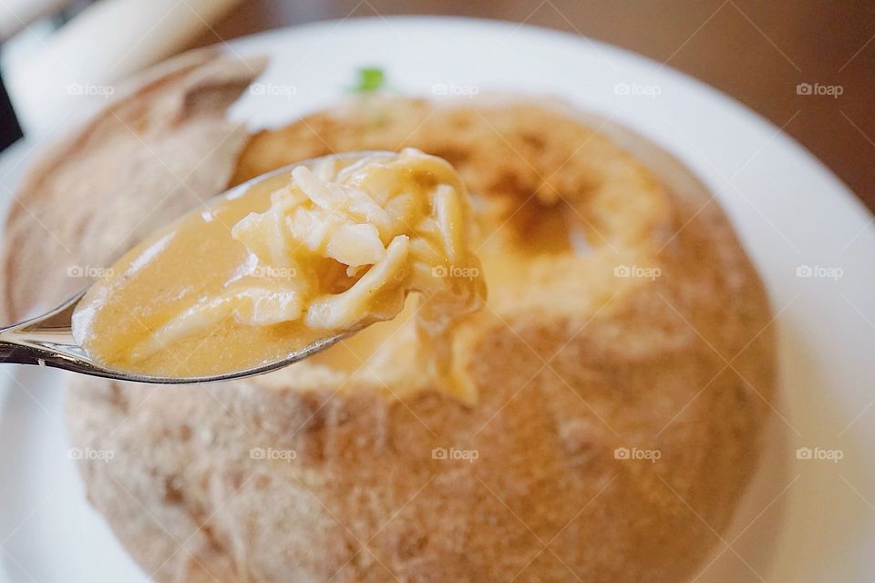 Lobster cream soup served in bread bowl. Seafood starter. 