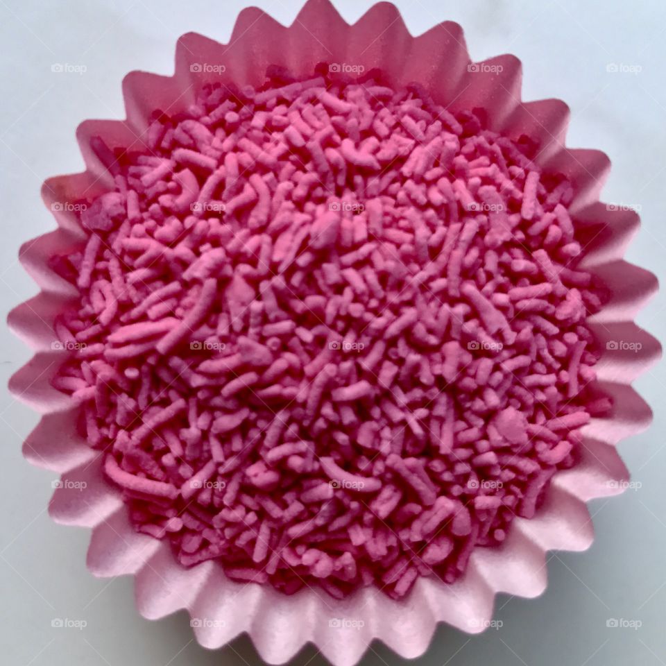 Pink candy sprinkles in mini cupcake case