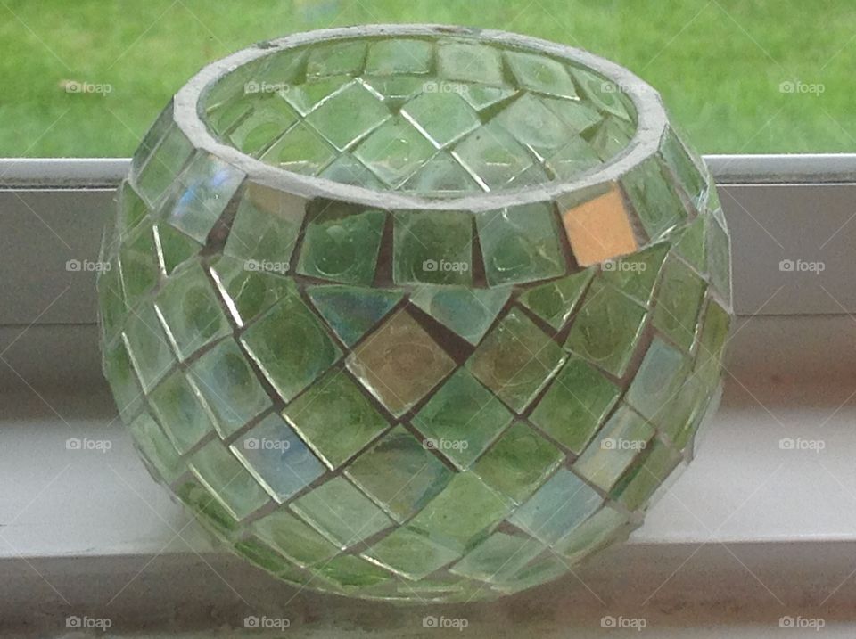 A green glass candle holder.