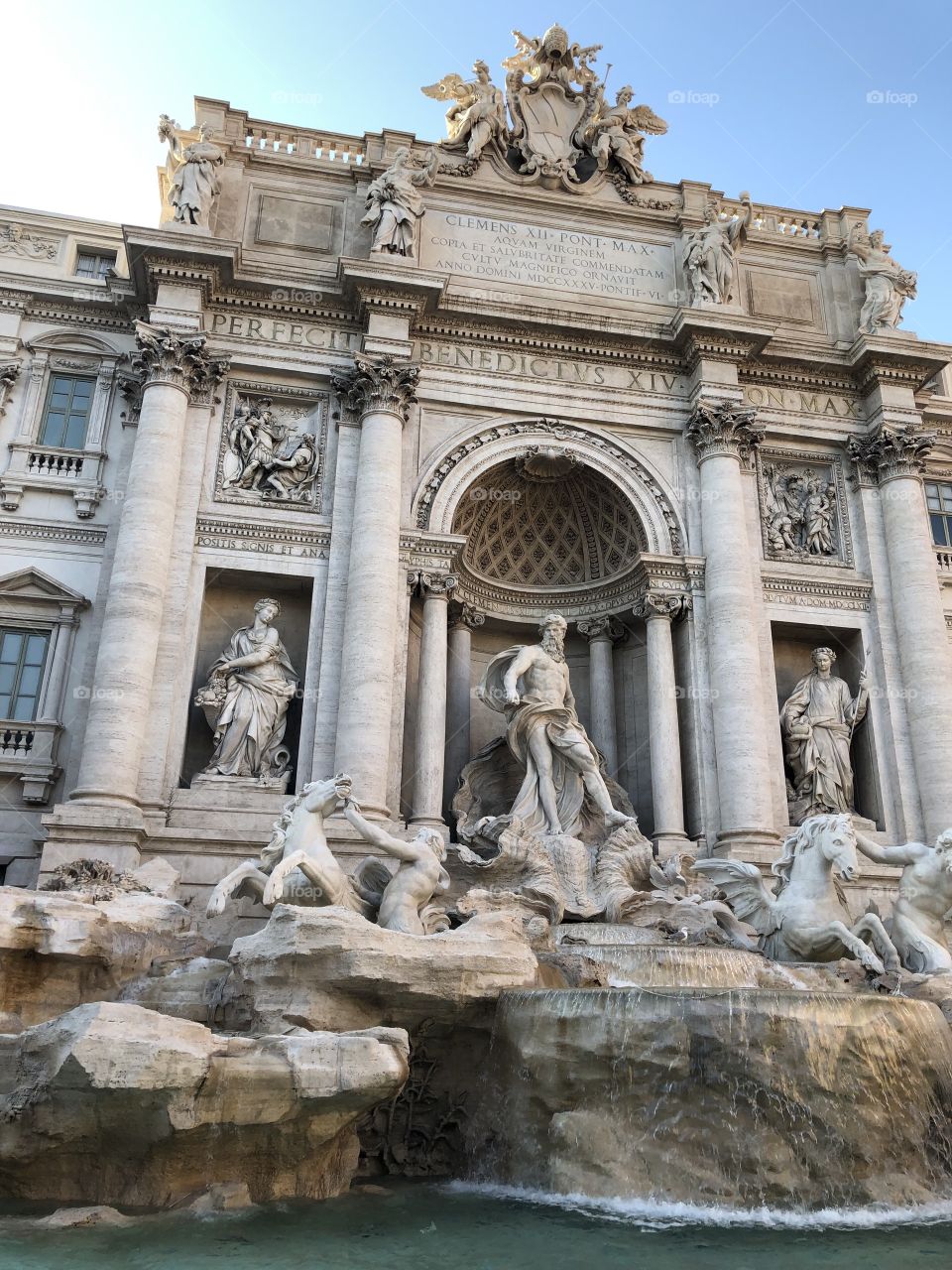 This is a beautiful picture of the trevi fountain during a summer day, it was taken by me while I was visiting it was very busy that day but i managed to get a picture with no one in it 