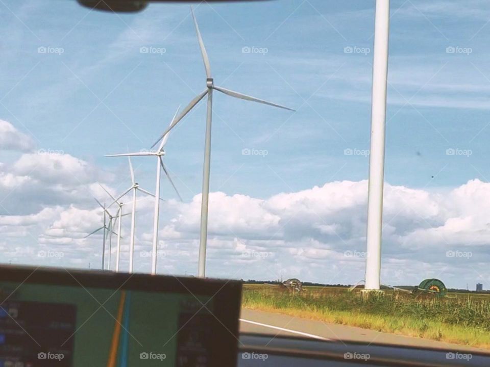 windmills || Windmills are machines that harness the power of wind to generate mechanical energy, which can be used for a variety of purposes such as grinding grain, pumping water, or generating electricity.Windmills typically consist of a tall tower