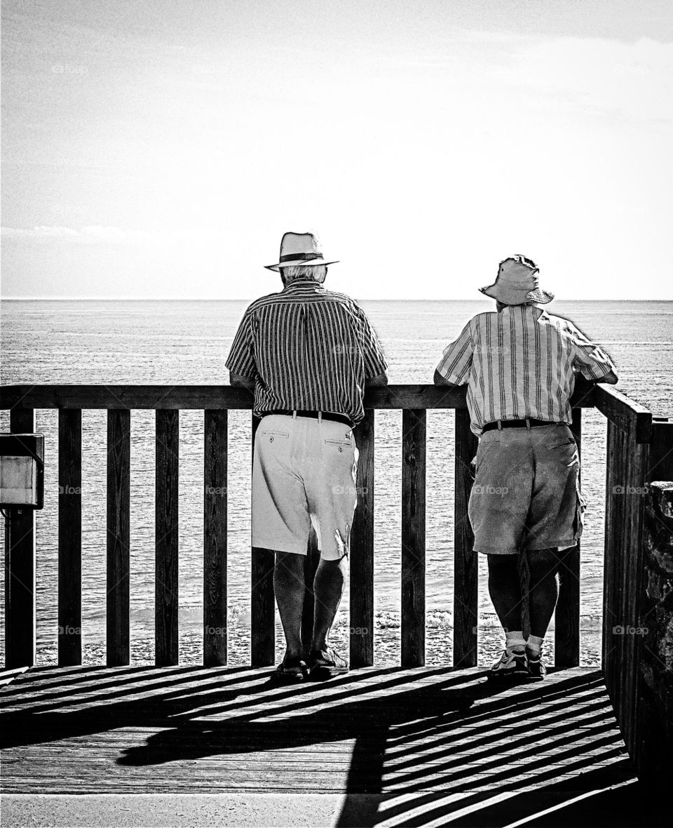 Rear view of person standing against sea