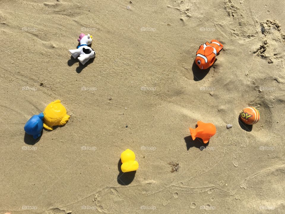 Children beach toys on sand