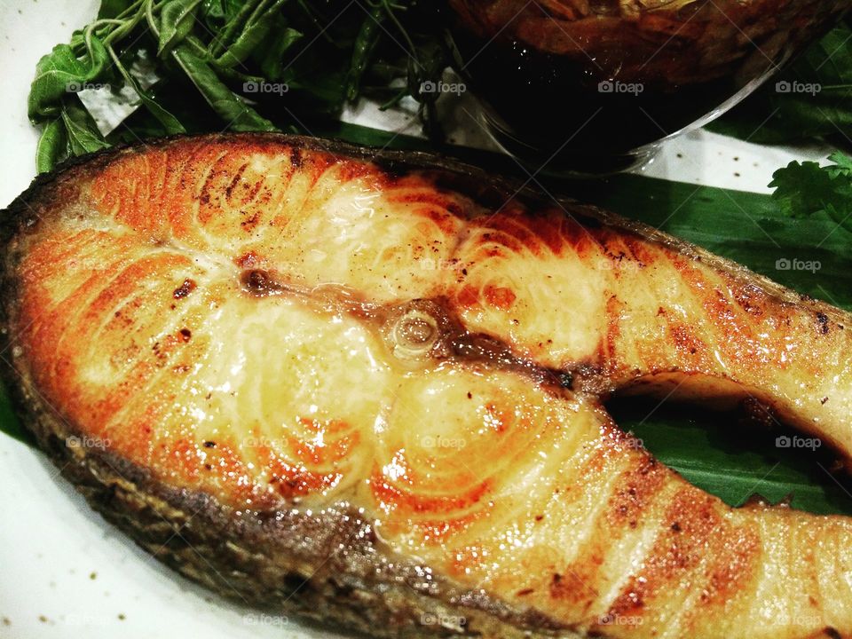 Grilled Salmon with vegetable on white plate.