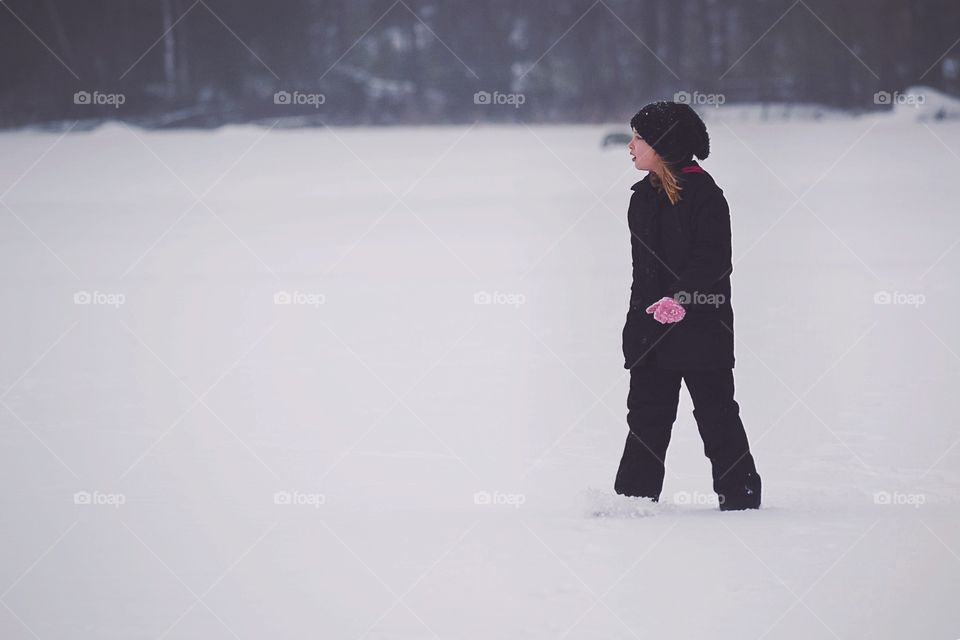 Girl walking in winter snow