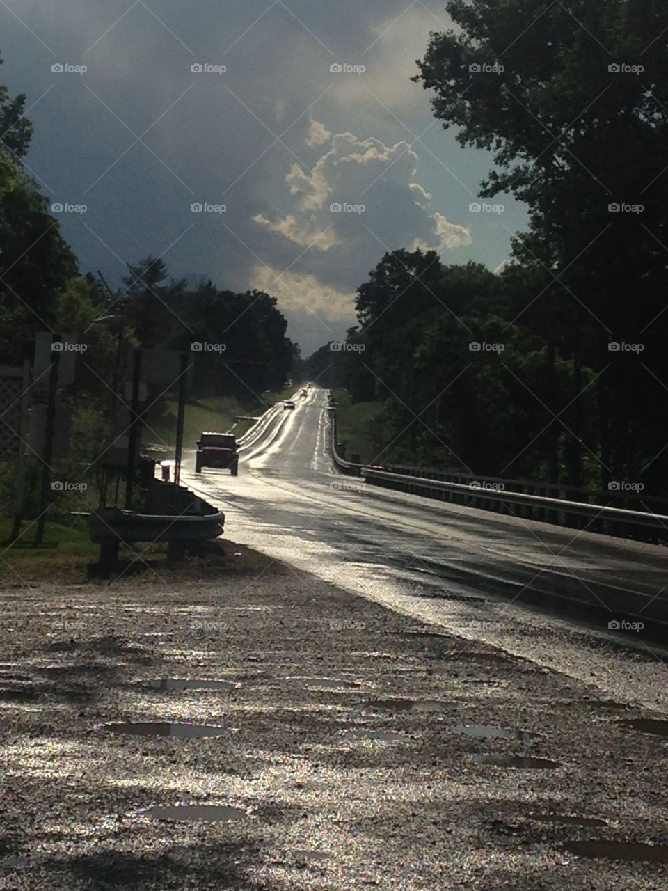 wet road cloud but sunny .