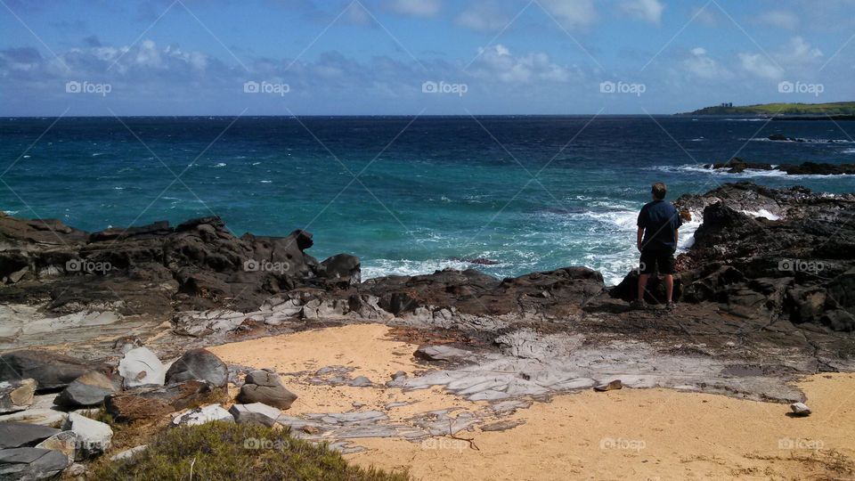 Rear view of man standing on beach