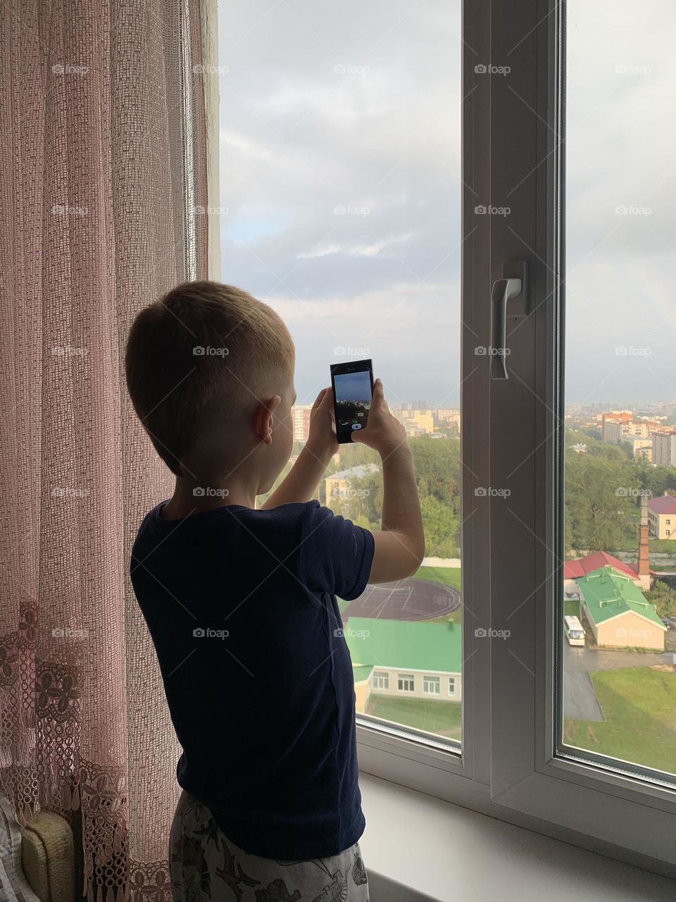 Boy doing photo in window 