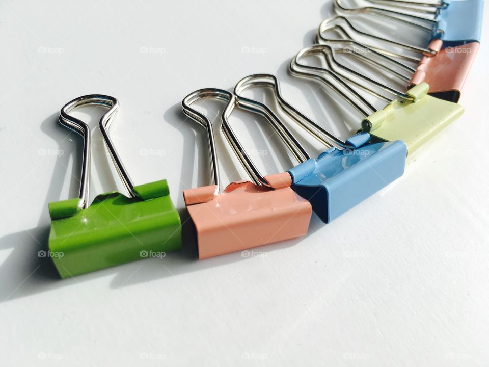 This is random , but very beautiful pastel paper clips on a white background . 