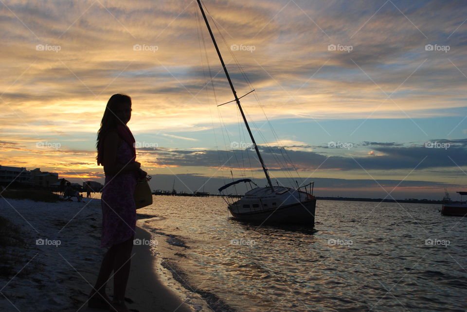 A girl and a boat at sunset