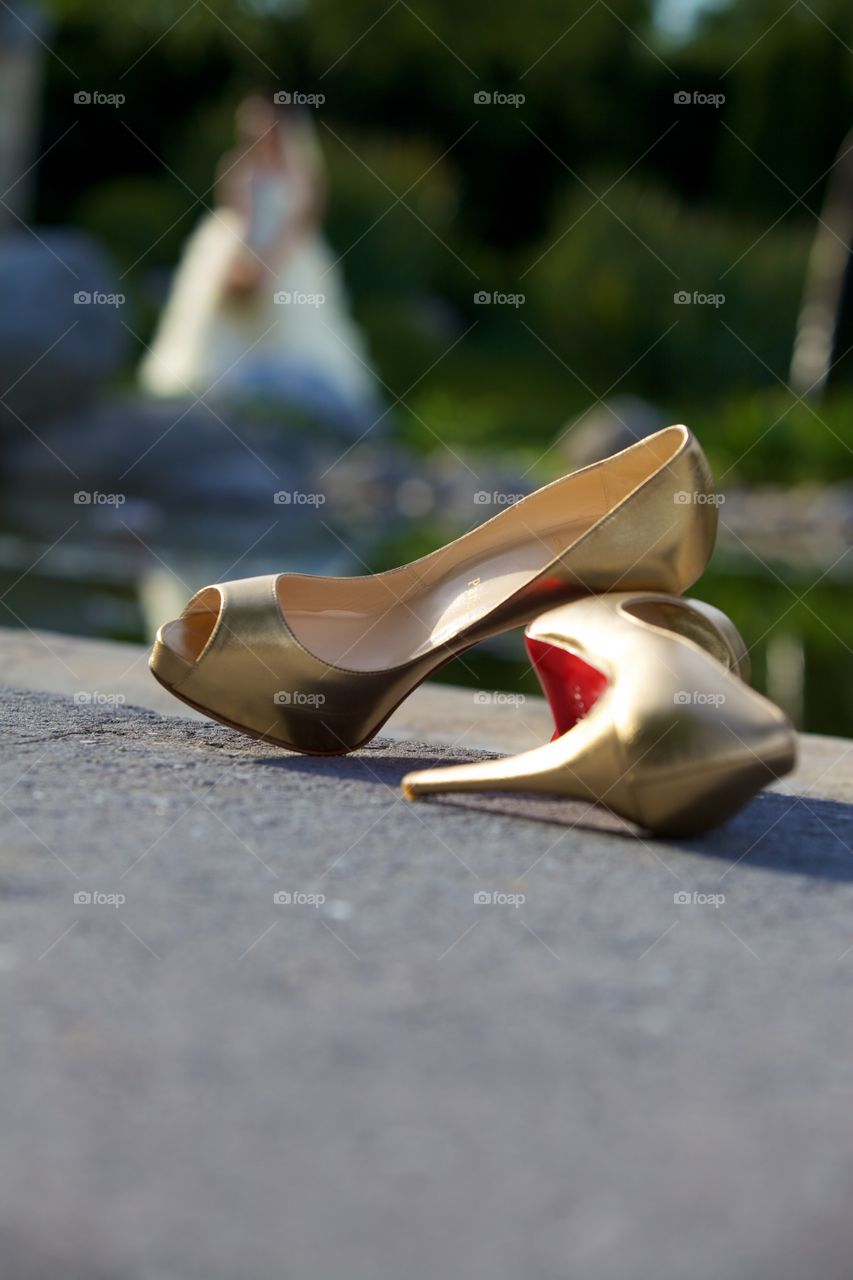 Fancy heel shoes and bride. Christian Louboutin high heel shoes and bride on background