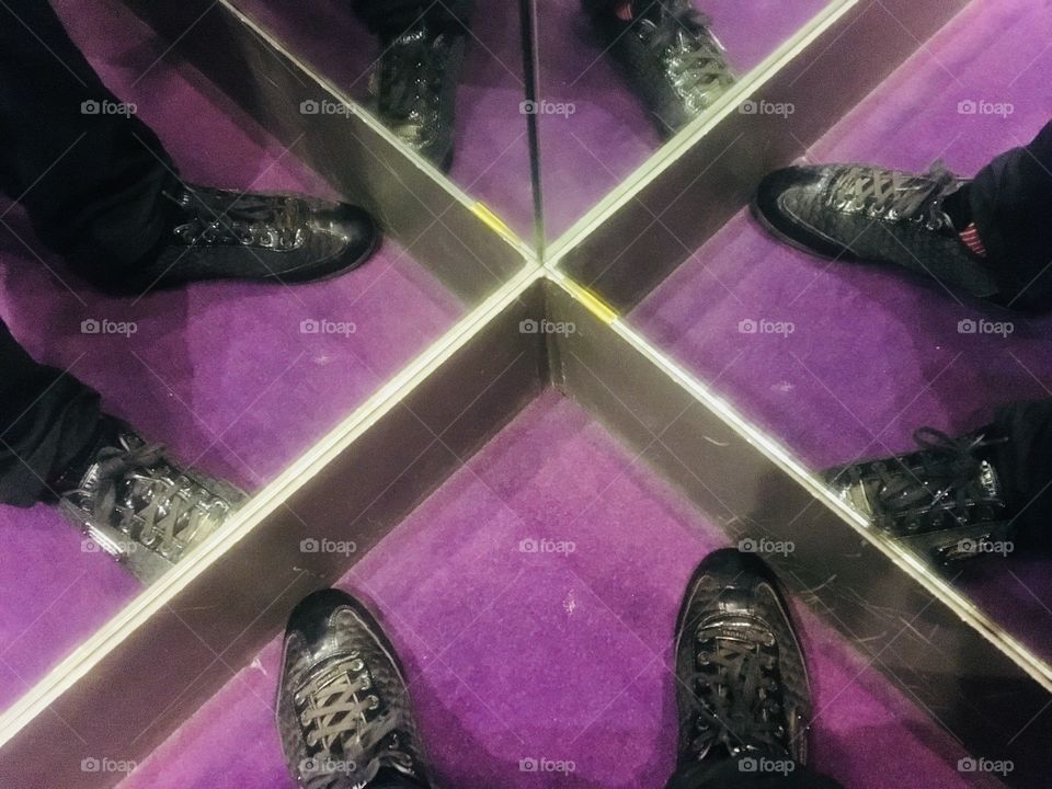 Standing in the corner of the changing room at Impeccable Formal Wear, Hatch End, Greater London. Purple carpet. Mirrored sides. Winter shopping.