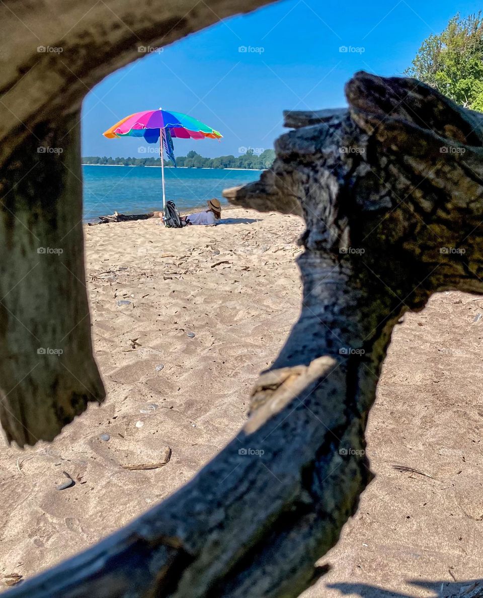 A driftwood framed Big Sandy Bay Beach capture.