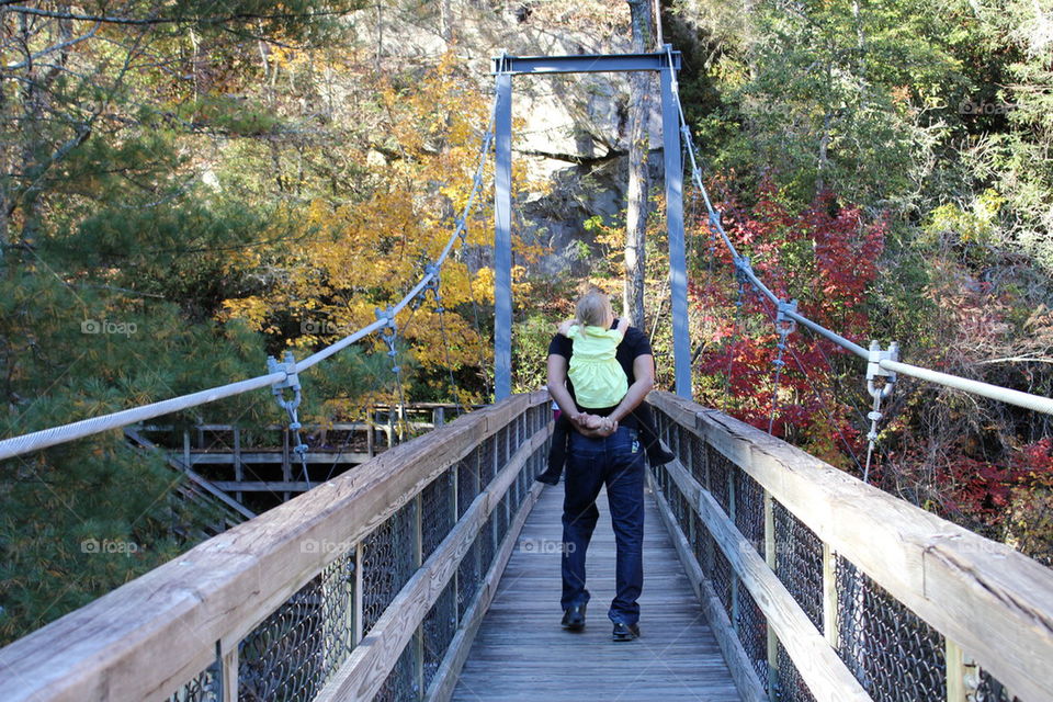 Father daughter on suspension bridge