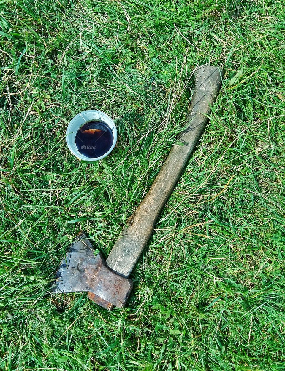 tea and ax in the grass