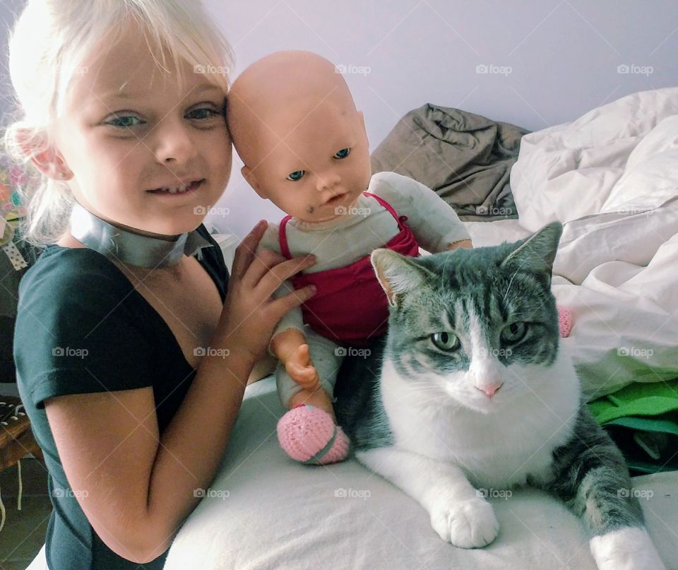 playing together - a girla her doll and a cat