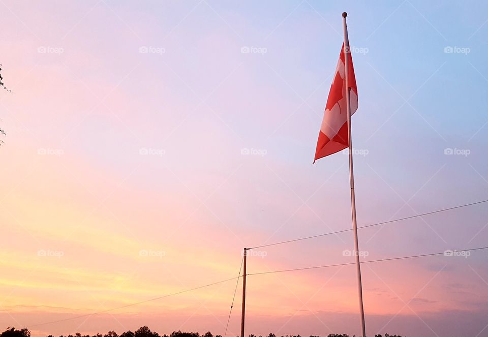 A beautiful evening sky with the Canada flag. Country life is always the best life!