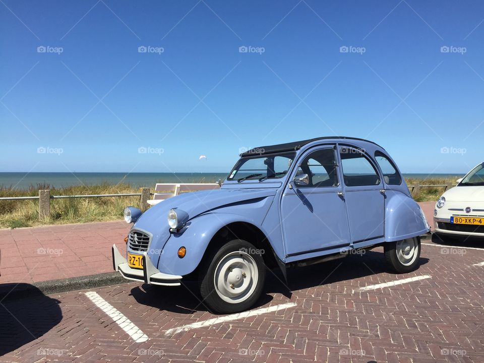Citroen 2CV at the beach. Citroen 2CV Special in front ofthe beach in the netherlands