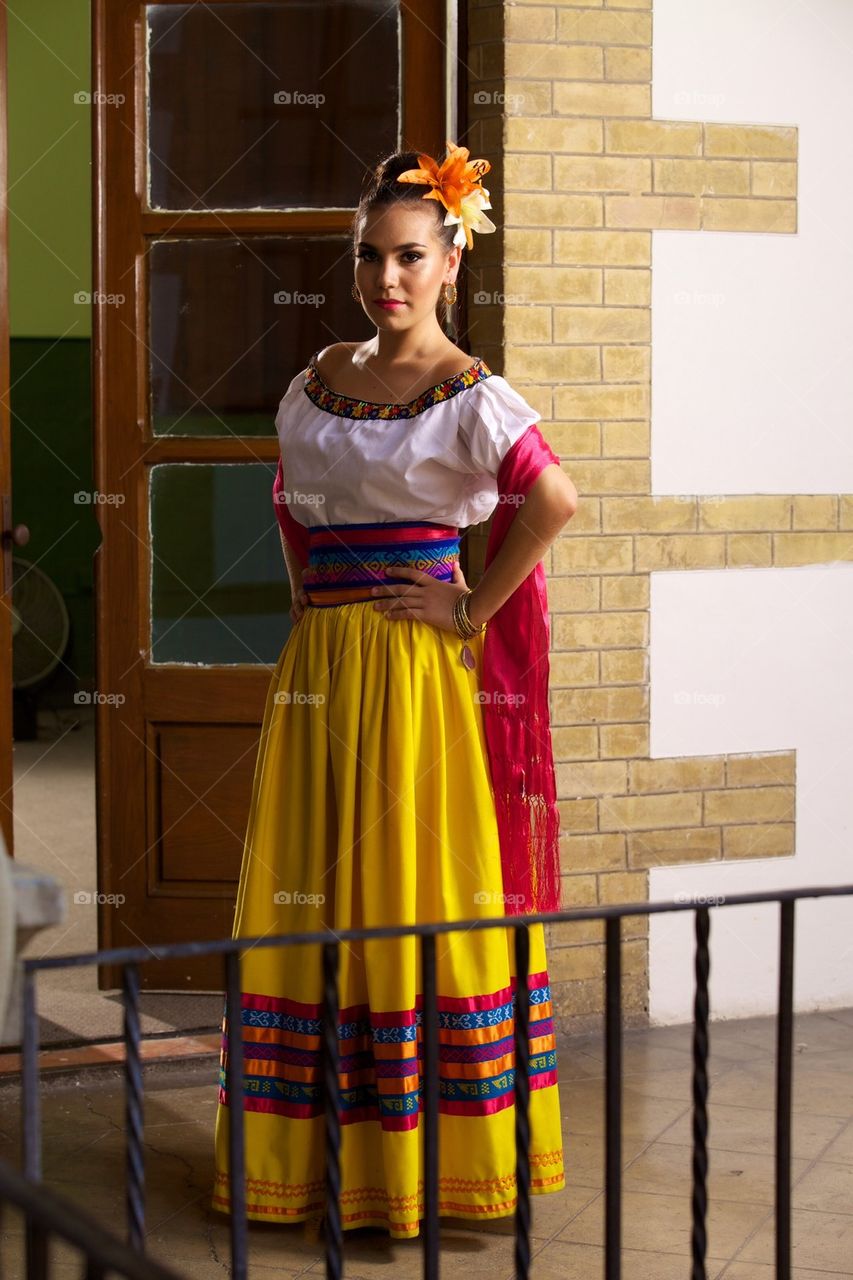 Beautiful woman dressed in handmade folkloric mexican dress