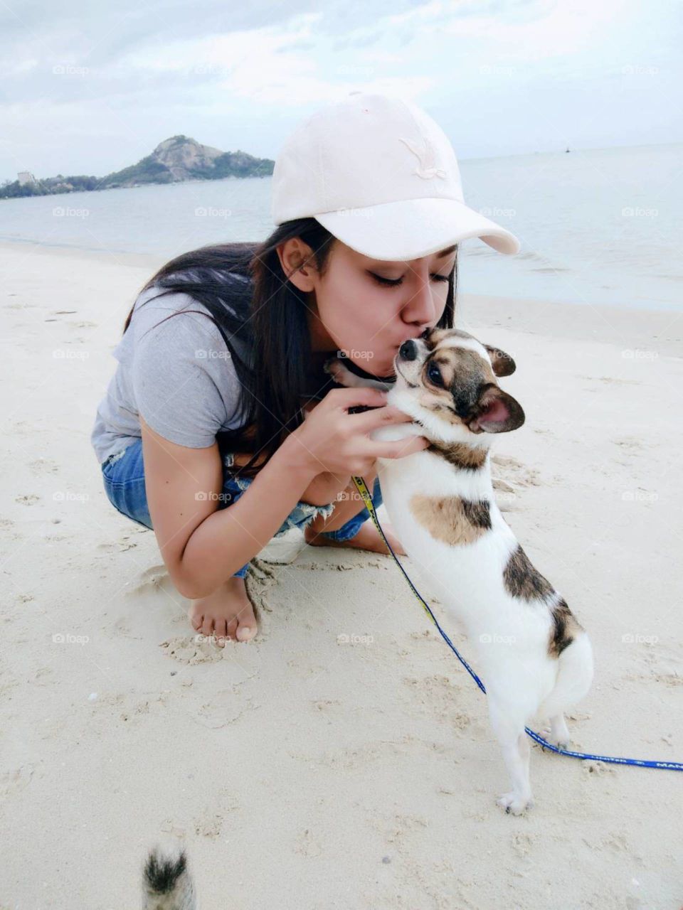Kiss the lovely dog on the beach, Hua-Hin,Thailand.