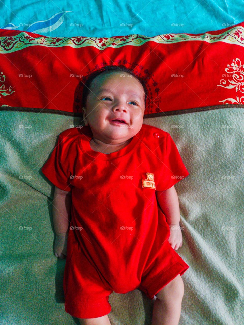 smiles baby with red cloth
