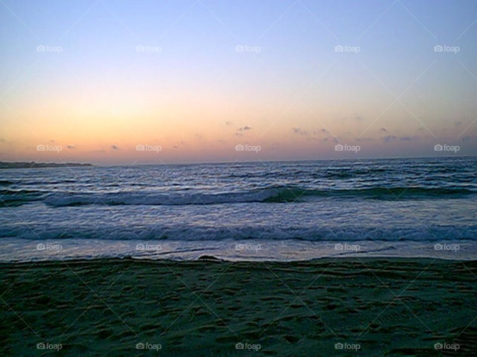 Waves coming into the beech during sunset.