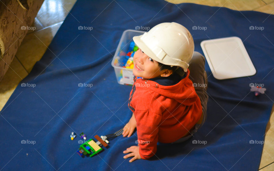Beautiful kid playing with colorful blocks toys 